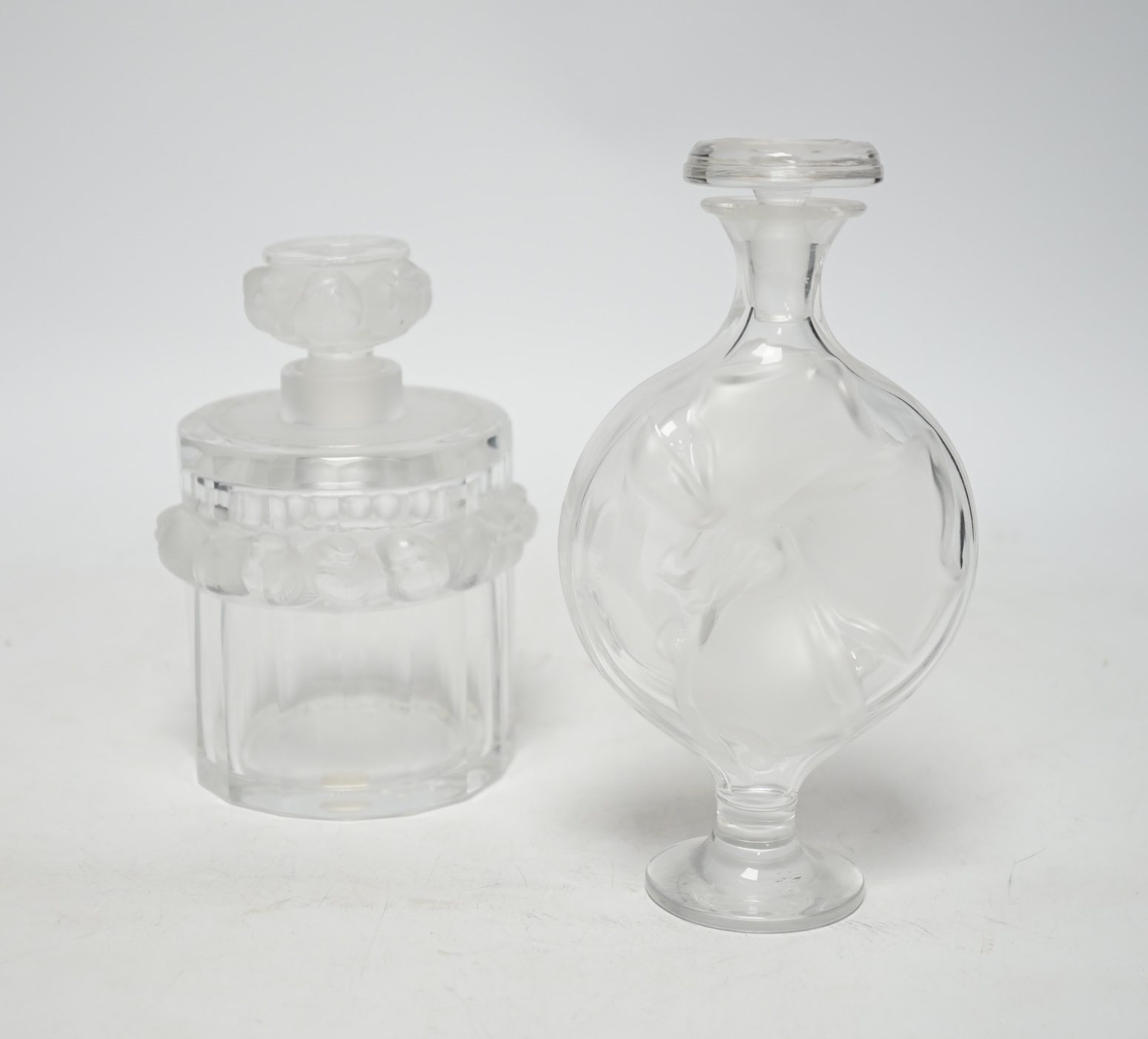 Two Lalique glass scent bottles and stoppers comprising ‘Robinson’ and ‘Moulin Rouge’, signed to the bases, largest 17cm high
